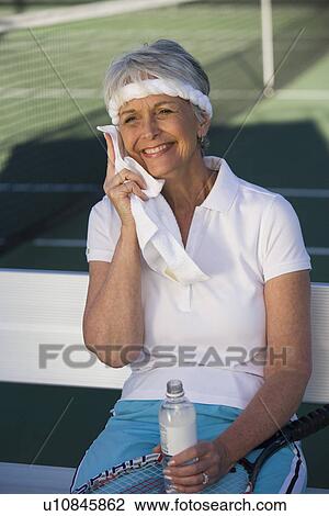 Female tennis player toweling face View Large Photo Image Stock Image - Female tennis player toweling face. Fotosearch