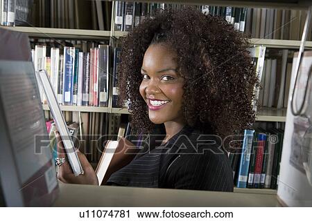 Female university student in library, portrait View Large Photo Image Stock Image - Female university student in library, portrait. Fotosearch