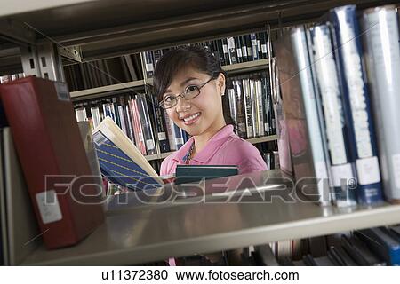 Female University student in library, portrait View Large Photo Image Stock Image - Female University student in library, portrait. Fotosearch