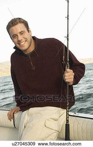 Stock Photo - Fisherman on boat, (portrait). Fotosearch