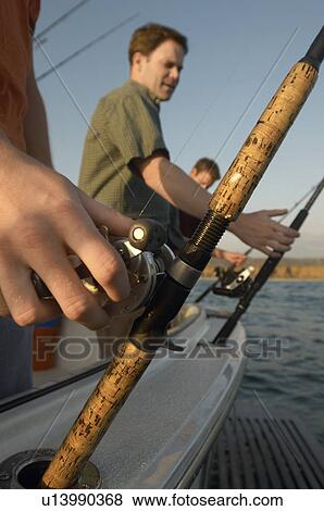 Stock Photo - Fishermen on boat. Fotosearch