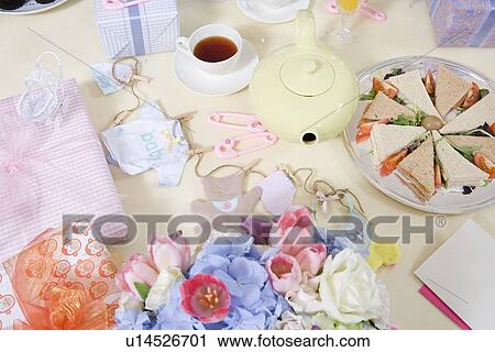 Stock Image - Food and Flowers on a Table at a Baby Shower. Fotosearch