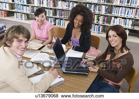 Four University students studying in library View Large Photo Image Stock Photo - Four University students studying in library. Fotosearch