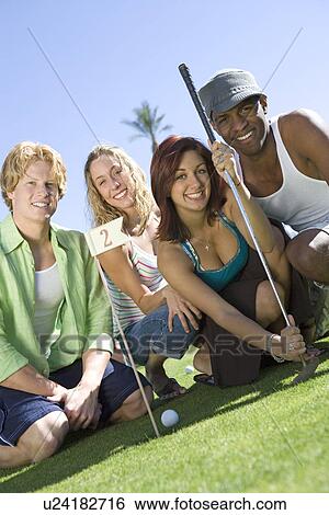 Four Young Friends on Golf Course, Portrait View Large Photo Image Stock Photograph - Four Young Friends on Golf Course, Portrait. Fotosearch