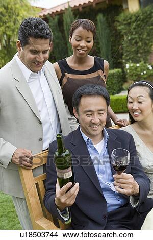 Picture - Friends celebrating with wine outdoors. Fotosearch