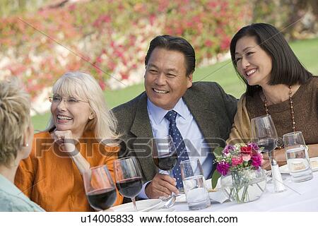 Friends drinking wine in garden View Large Photo Image Stock Image - Friends drinking wine in garden. Fotosearch