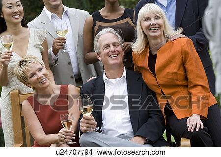 Friends drinking wine outdoors View Large Photo Image Picture - Friends drinking wine outdoors. Fotosearch