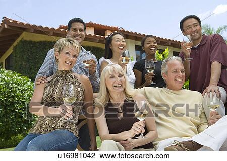 Friends drinking wine outdoors View Large Photo Image Stock Image - Friends drinking wine outdoors. Fotosearch