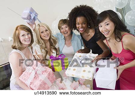Friends standing Together holding gifts at Bridal Shower View Large Photo Image Stock Image - Friends standing Together holding gifts at Bridal Shower. Fotosearch