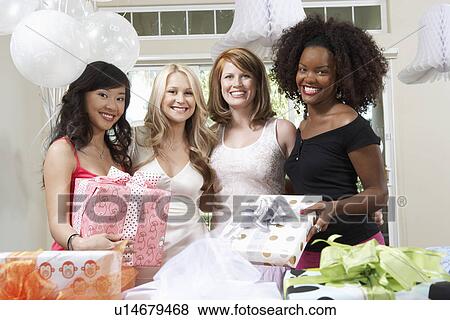 Stock Photo - Friends standing Together with gifts at Bridal Shower. Fotosearch