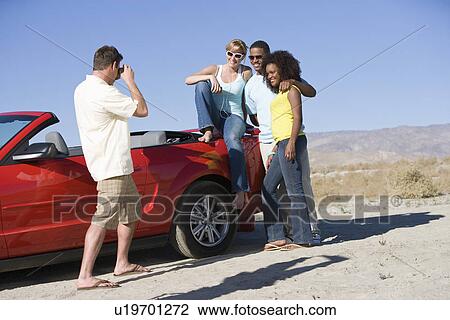 Friends Taking a Photograph Outdoors View Large Photo Image Stock Image - Friends Taking a Photograph Outdoors. Fotosearch