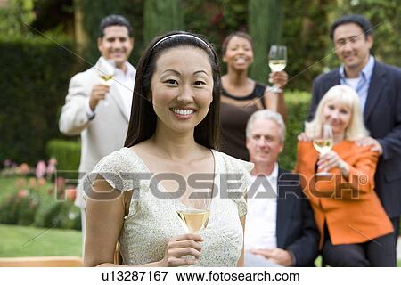Stock Photo - Friends toasting outdoors. Fotosearch