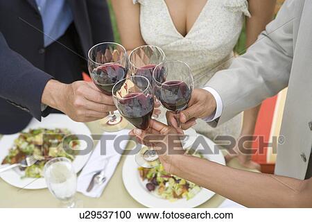 Friends toasting wine outdoors, close-up View Large Photo Image Stock Image - Friends toasting wine outdoors, close-up. Fotosearch