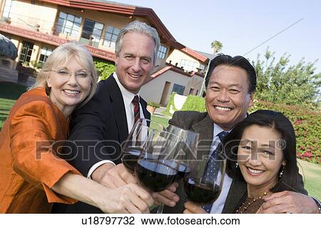 Friends toasting with wine in garden View Large Photo Image Stock Image - Friends toasting with wine in garden. Fotosearch