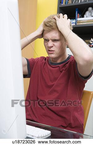 Stock Photograph - Frustrated Man Using a Computer. Fotosearch