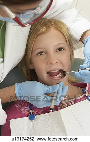 Girl (7-10) having teeth examined at dentists View Large Photo Image Stock Image - Girl (7-10) having teeth examined at dentists. Fotosearch