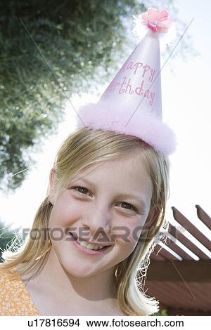 Picture - Girl in birthday hat. Fotosearch