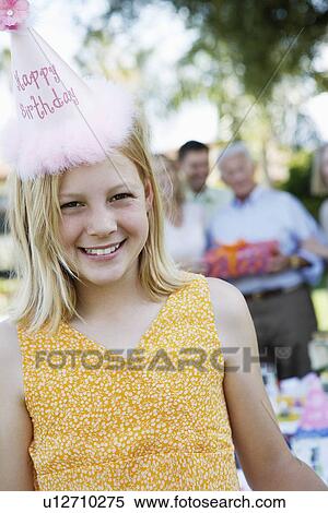 Girl Wearing Birthday Hat standing outside at party View Large Photo Image Stock Photography - Girl Wearing Birthday Hat standing outside at party. Fotosearch