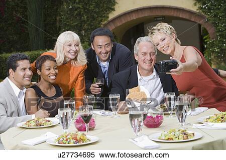 Stock Photography - Group of friends posing for photograph outdoors. Fotosearch
