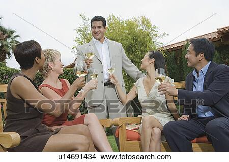 Picture - Group of friends toasting outdoors. Fotosearch