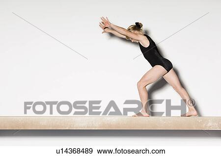 Gymnast(13-15) on balance beam preparing to do handstand, side view View Large Photo Image Stock Photo - Gymnast(13-15) on balance beam preparing to do handstand, side view. Fotosearch