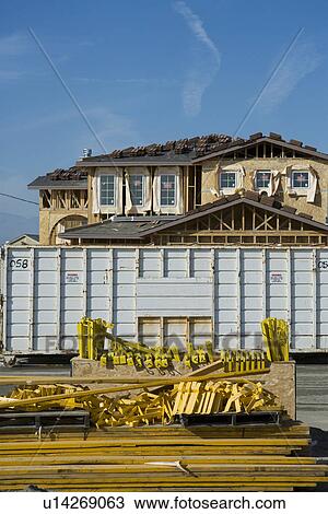 Stock Image - Half constructed house on construction site. Fotosearch