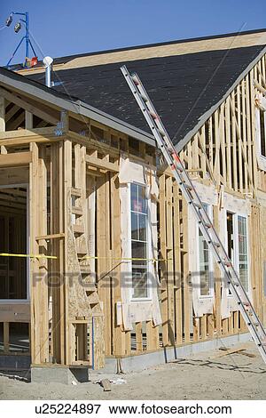 Ladder against wooden house construction View Large Photo Image Stock Photo - Ladder against wooden house construction. Fotosearch