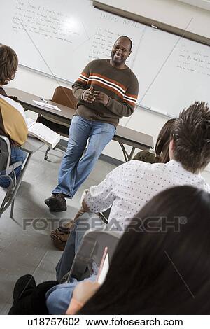 Lecturer teaching University students in classroom View Large Photo Image Stock Image - Lecturer teaching University students in classroom. Fotosearch