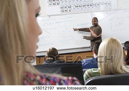 Lecturer teaching University students in classroom View Large Photo Image Stock Photo - Lecturer teaching University students in classroom. Fotosearch