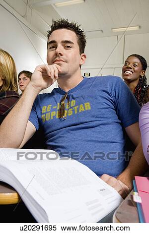 Stock Photography - Male student in lecture hall, (portrait). Fotosearch