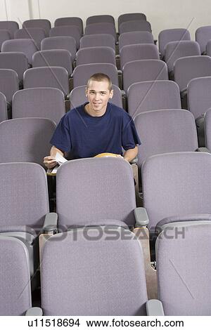Picture - Male student sitting in lecture hall, portrait. Fotosearch