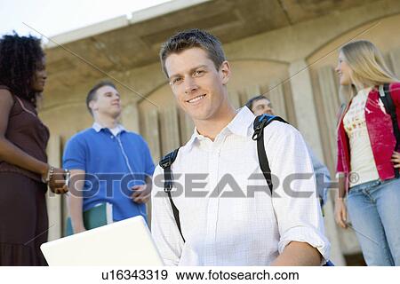 Male student using laptop outdoors, (portrait) View Large Photo Image Stock Photo - Male student using laptop outdoors, (portrait). Fotosearch
