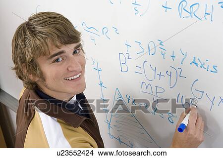 Male student writing maths equations on whiteboard View Large Photo Image Picture - Male student writing maths equations on whiteboard. Fotosearch