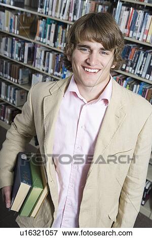 Stock Photo - Male University student in library, portrait. Fotosearch