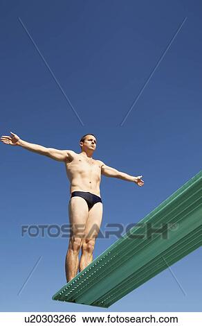 Stock Photograph - Man about to dive backwards off a diving board. Fotosearch