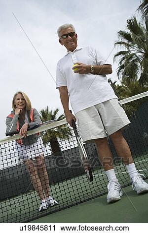 Man and woman on tennis court View Large Photo Image Stock Image - Man and woman on tennis court. Fotosearch