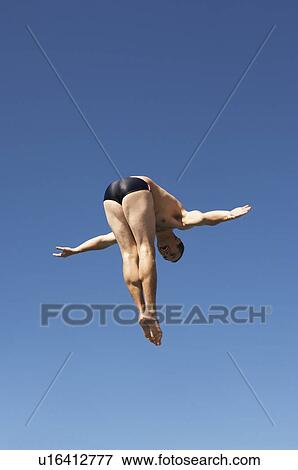 Man diving in pike position, mid air View Large Photo Image Stock Photo - Man diving in pike position, mid air. Fotosearch