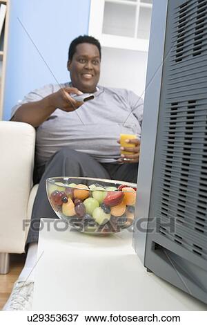 Stock Photo - Man Eating Bowl of Fruit. Fotosearch
