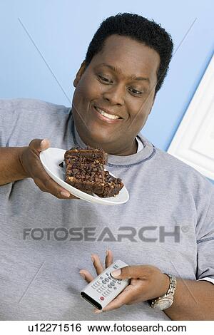 Man Eating Brownies View Large Photo Image Stock Photograph - Man Eating Brownies. Fotosearch