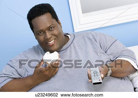 Stock Image - Man Eating Donut. Fotosearch