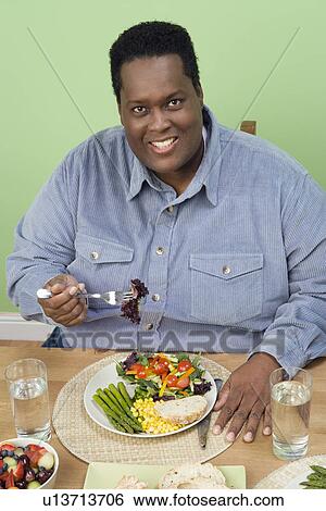 Man Eating Fruits and Vegetables View Large Photo Image Stock Photograph - Man Eating Fruits and Vegetables. Fotosearch