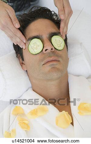 Picture - Man having facial treatment, close-up. Fotosearch