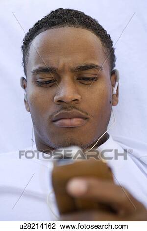 Stock Image - Man Holding MP3 Player. Fotosearch