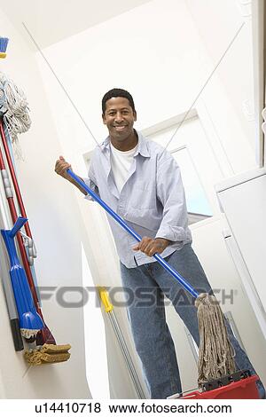 Man mopping floor View Large Photo Image Stock Photo - Man mopping floor. Fotosearch