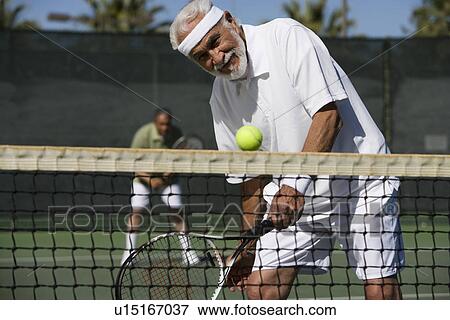Stock Photo - Man playing tennis. Fotosearch