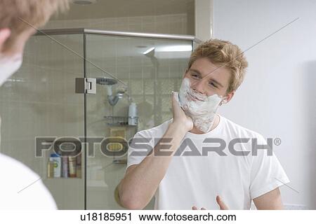 Stock Image - Man Shaving in Mirror. Fotosearch