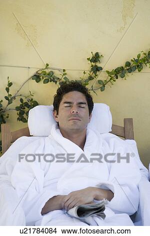 Picture - Man sleeping in bathrobe, outdoors. Fotosearch