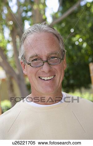 Stock Photography - Man smiling outdoors, portrait. Fotosearch