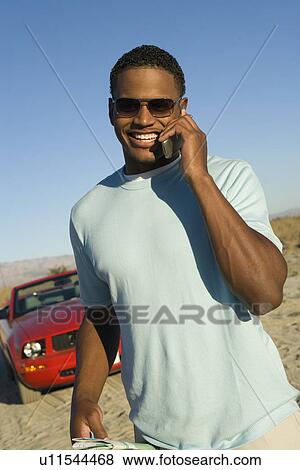 Stock Photo - Man Using Cell Phone. Fotosearch