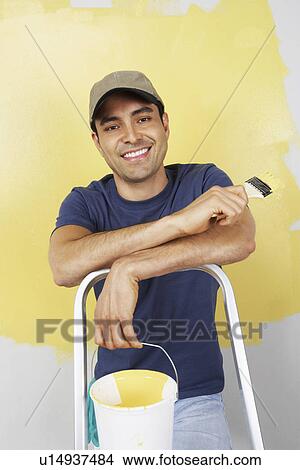 Man with paintbrush and paint can, portrait View Large Photo Image Picture - Man with paintbrush and paint can, portrait. Fotosearch